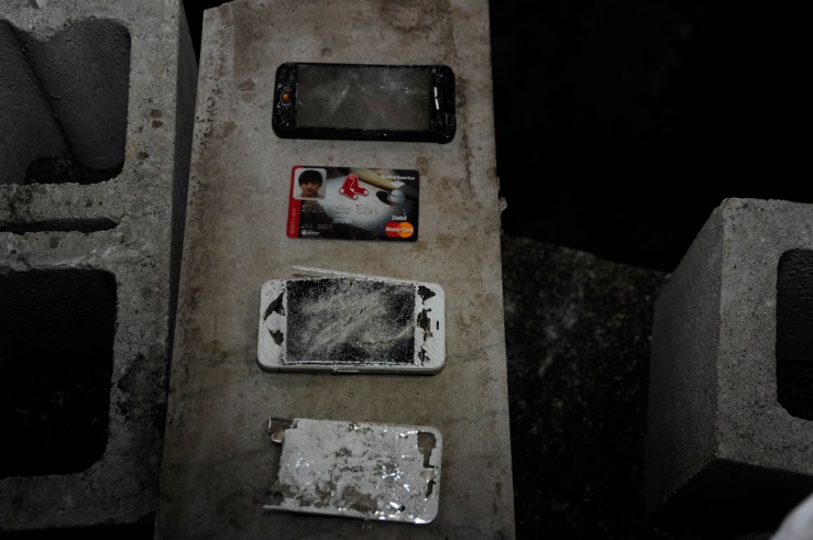 Exh 811 - 07 Smashed phones &amp; ATM card (lined up)